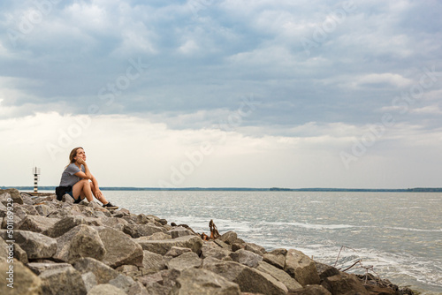 Beautiful girl on the sea with blue sky and clouds