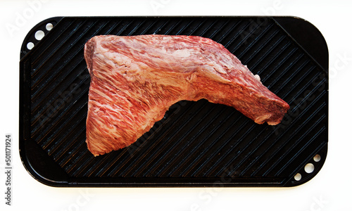 Raw tri-tip steak on grilling pan 