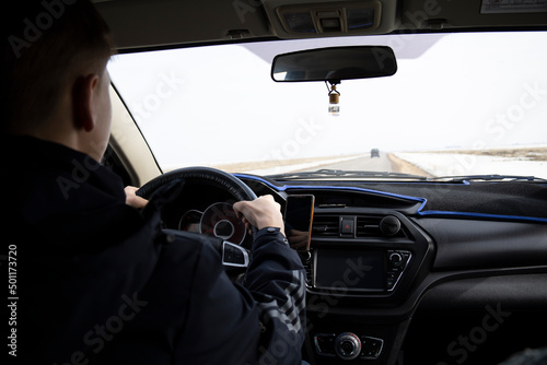 Man looking straight driving a car on the road © Igor Bastrakov