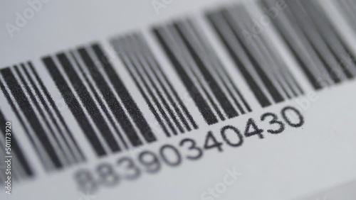 Scanner With Red Laser Scanning a Bar Code on a Product Closeup