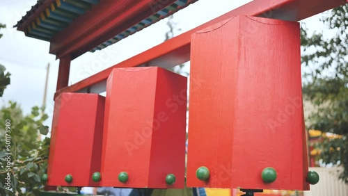 Rotation of the red prayer drums outside the Buddhist temple. photo
