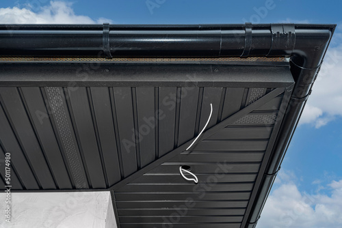 A modern graphite herringbone roof lining is attached to the trusses, visible cables and holes for LED lighting.