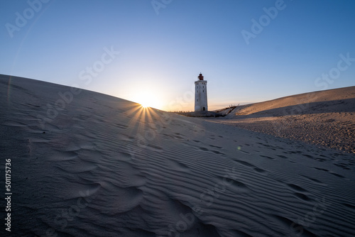 Rubjerg Knude Fyr Lighthouse in the sand dunes in northern denmark north jutland region at sunset