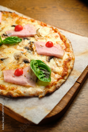 Pizza with bacon and ham and tomatoes