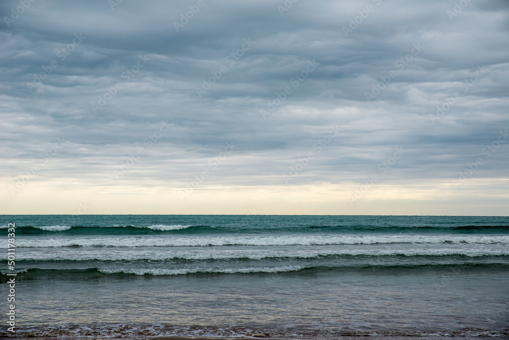 calm waves on the sea on a cloudy day