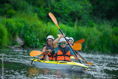 Adult kayakers are kayaking together