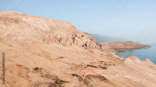 Rocky desert landscape with ocean sea and blue sky in summer