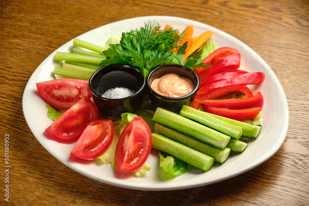 Fresh vegetables (cucumbers, tomatoes, dill, shallots) on a white plate Fresh vegetables (cucumbers, tomatoes, dill, shallots) on a white plate