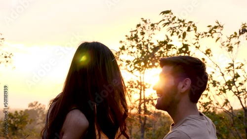 Happy love couple take photo and selfie during camping and relax in forest hiking trip, beautiful Asian woman and caucasian man happiness spend time tpgether, sunset liesure romantic moment photo