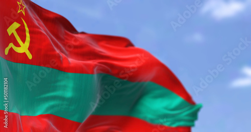 Side view of the national flag of Transnistria waving in the wind. photo