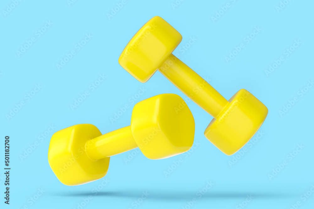 Pair of rubber yellow dumbbells isolated on blue background Pair of rubber yellow dumbbells isolated on blue background