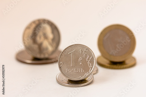 Rise and fall of Russian ruble, Russian ruble coin, dollar and euro coins on white background, copy space, mock up.
