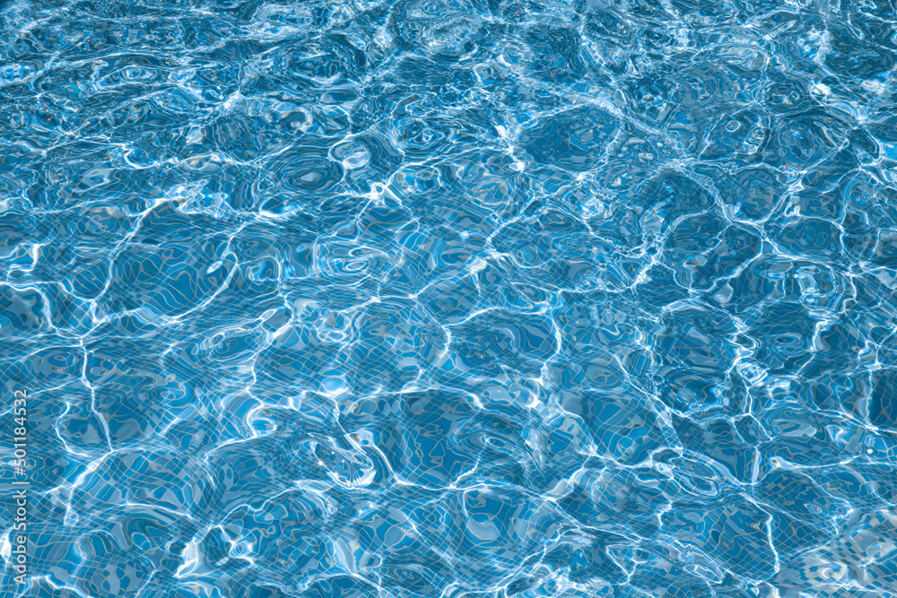 Background, water waves in the pool with sun reflection