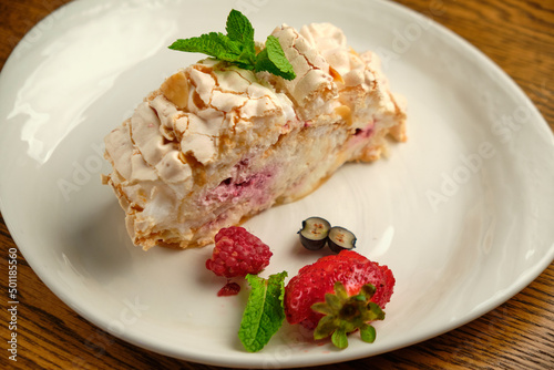 Cake with meringue roll with cream and raspberries