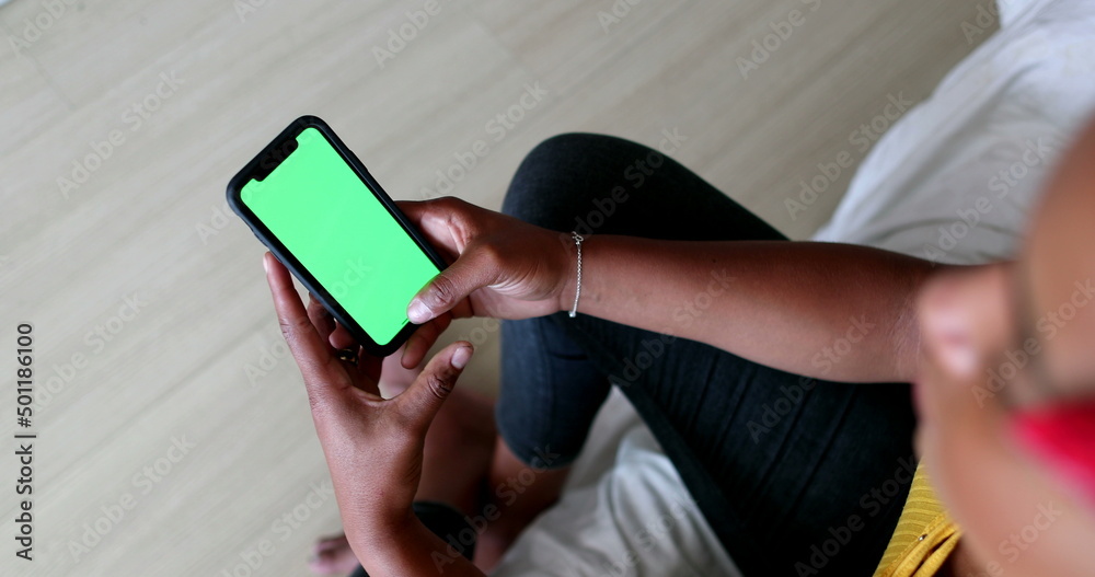 Black woman hands holding cellphone with green screen Black woman hands holding cellphone with green screen