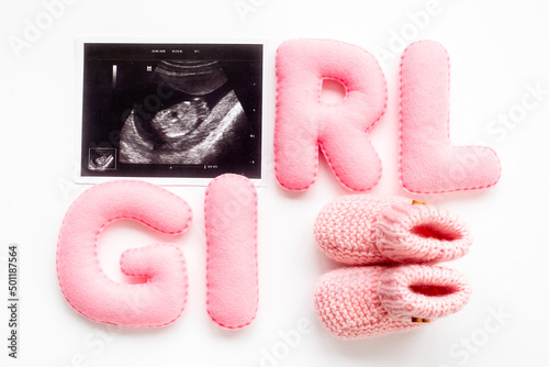 Ultrasound scan of unborn baby with letters girl