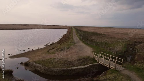 Aerial view drone flight of bridge, path and moorland river
