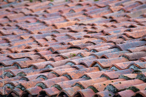 Background of arabic tiles or curves. Construction detail close up. Red tiles roof background. Background of old roof tiles.