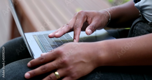 African American woman using laptop computer outside
