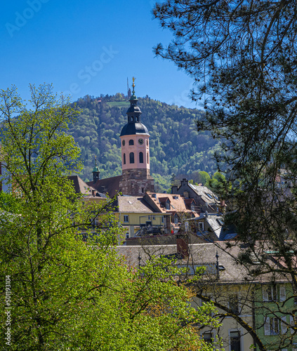 The steeple of the collegiate church in Baden Baden in the background the Merkur mountain. Baden Wuerttemberg, Germany, Europe