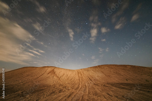 Night scene with sand dune in moon light and starry sky