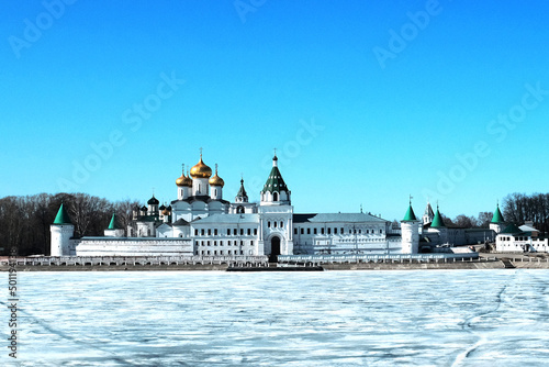 View of the monastery and churches across the river, covered with ice in winter, on a sunny day