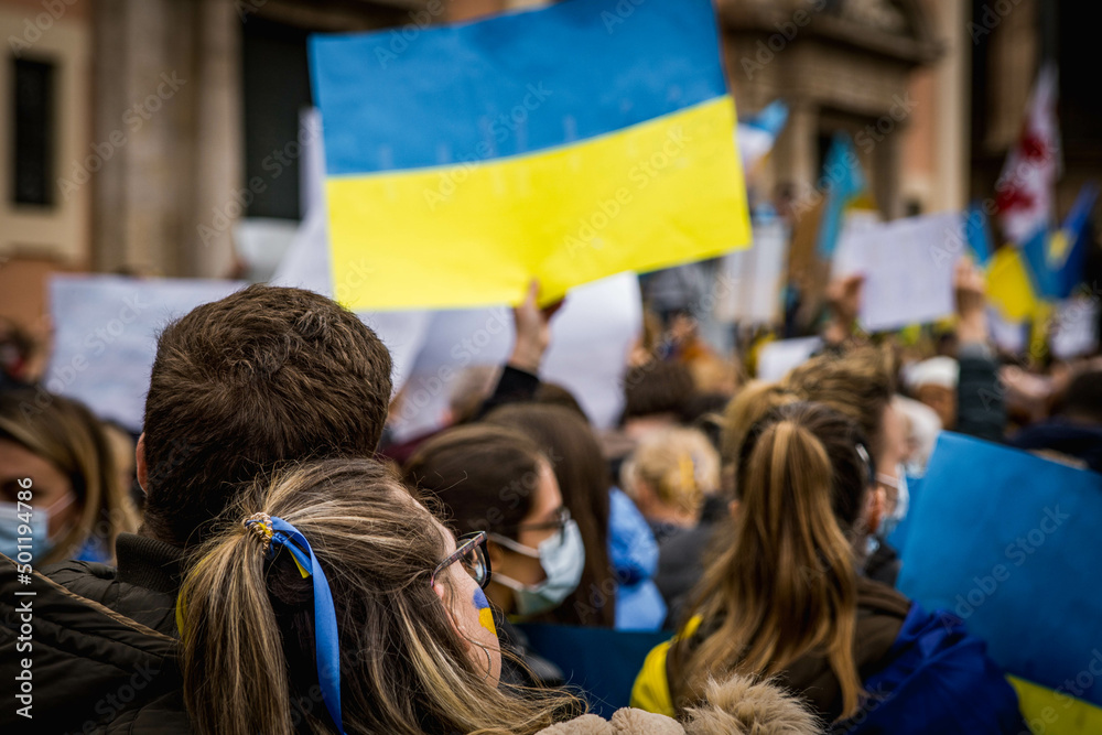 Young Couple Leaning on Each Other at Demonstration in Support of Ukraine with National Flags Against the War with Russia