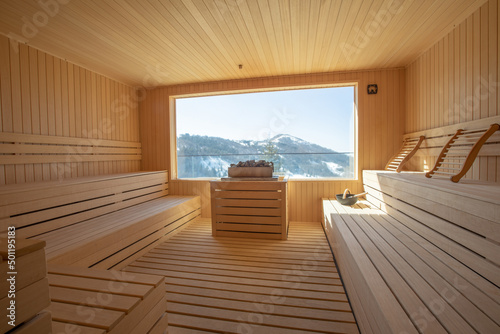 Empty wooden sauna room with traditional sauna accessories photo