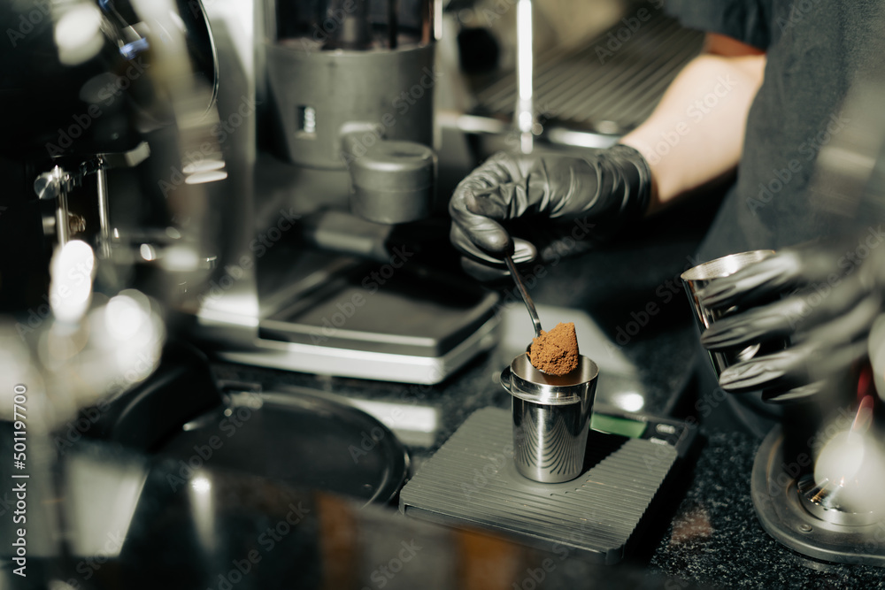 Close-up image of Grind coffee powder in measuring scoop in a Cafe coffee shop or restaurant. Process of Barista making coffee before put coffee powder into brewing machine. Cafe Service Concept Close-up image of Grind coffee powder in measuring scoop in a Cafe coffee shop or restaurant. Process of Barista making coffee before put coffee powder into brewing machine. Cafe Service Concept
