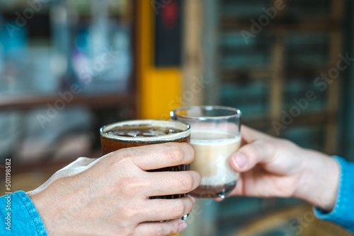 Close up of young couple hands clinking or toasting glasses of coffee talking sharing showing love and care, support, and Cheers, or business dealing, leisure time with friends idea. For Copy Space