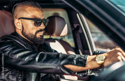 Stylish elegant man in sunglasses driving luxury car © paultarasenko