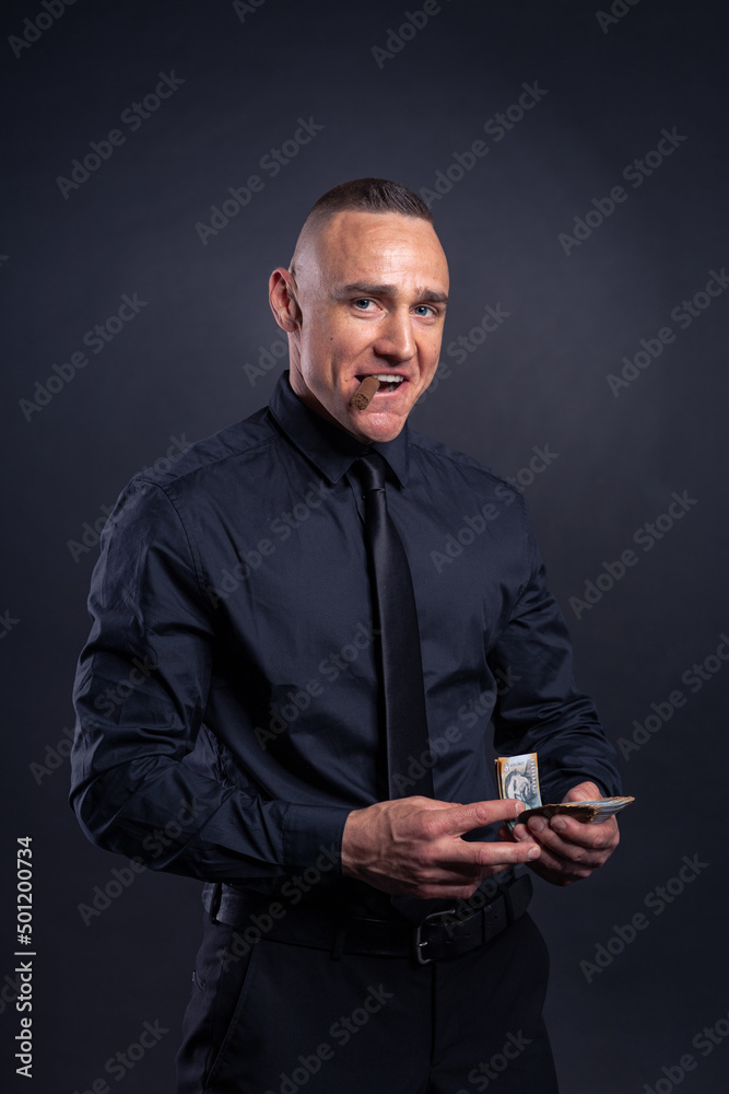Businessman showing off money in black shirt and tie Businessman showing off money in black shirt and tie
