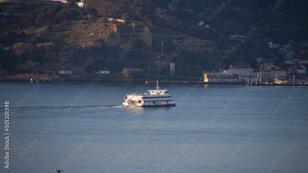 small boat walking on river Tejo in a sunny day