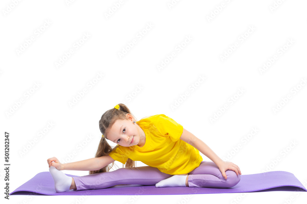 Little cute girl is practicing stretching on a gymnastic mat. Isolated on white background. Little cute girl is practicing stretching on a gymnastic mat. Isolated on white background.