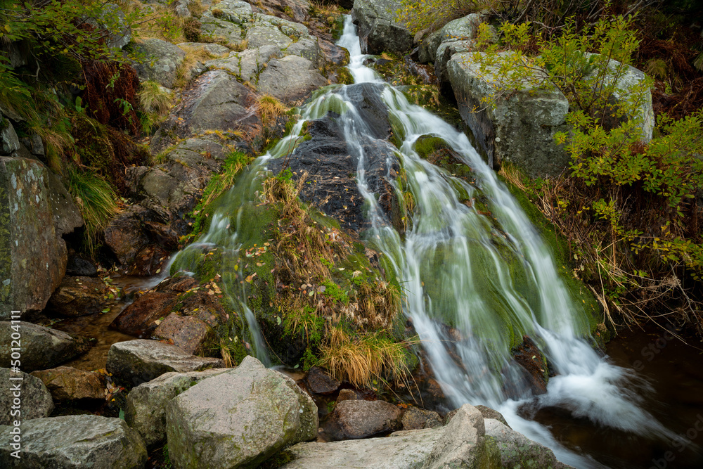 Photo of a small waterfall taken over a long time exposure Photo of a small waterfall taken over a long time exposure
