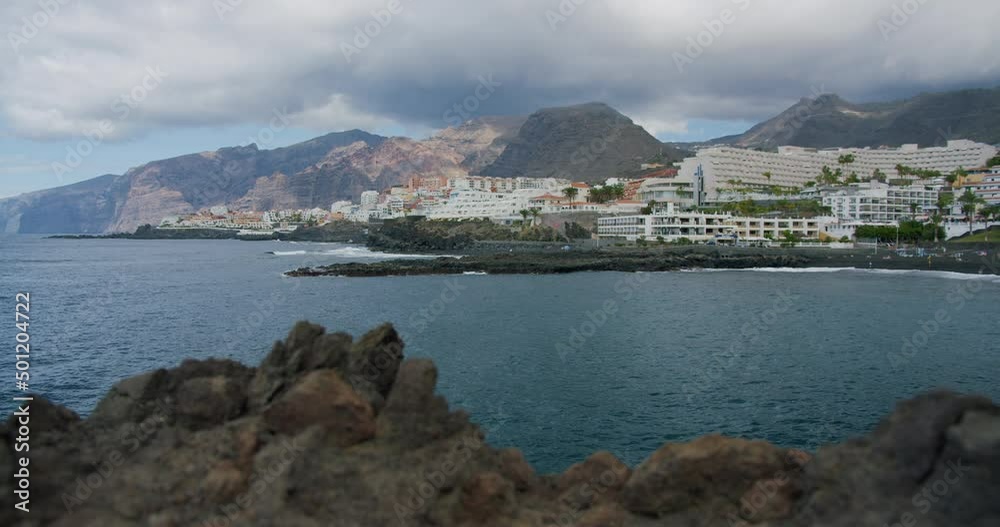 Acantilados de Los Gigantes - small resort town on the shores of the Atlantic Ocean on a sunny day. Acantilados de Los Gigantes - small resort town on the shores of the Atlantic Ocean on a sunny day.