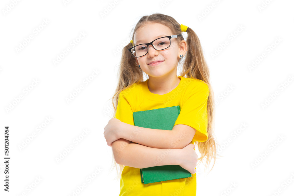 Cheerful young child girl with glasses holding a book to study isolated on a white background. Cheerful young child girl with glasses holding a book to study isolated on a white background.