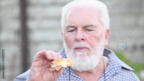 Man eating a deliciuos fig jelly with bread outdoor photo