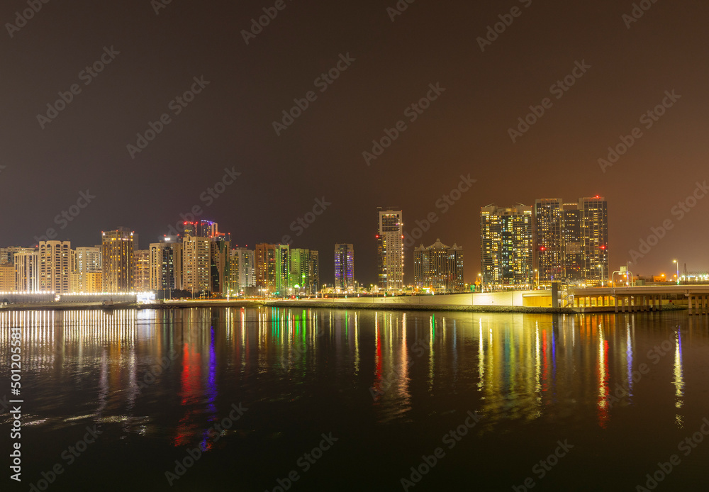 Obraz premium Night time cityscape of the Al Maryah district of Abu Dhabi, United Arab Emirates