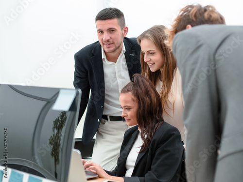 business team reading information on the office computer screen.