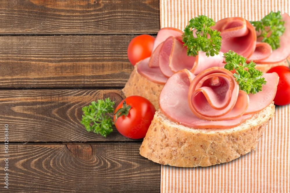 Traditional ham spiral sliced on desk with oranges and rosemary Traditional ham spiral sliced on desk with oranges and rosemary