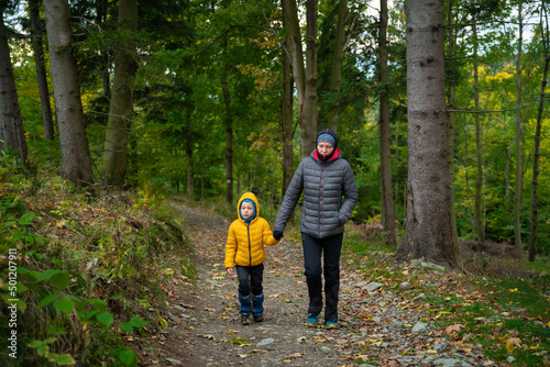 During the autumn, my mother and her little son go on a mountain trail.