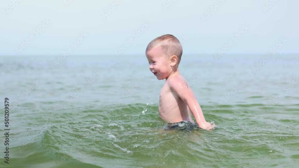 caucasian child kid boy swimming, diving, splashing in sea ocean underwater. little naked baby boy learning to dive under water in warm summer sea, during vacation. portrait wet drops, happy eyes caucasian child kid boy swimming, diving, splashing in sea ocean underwater. little naked baby boy learning to dive under water in warm summer sea, during vacation. portrait wet drops, happy eyes