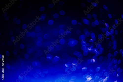 blue bokeh defocused glitter, abstract background with navy blue bokeh on a dark background
