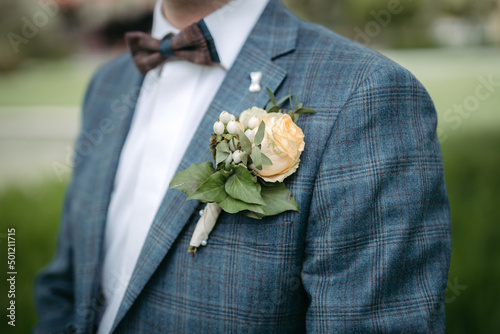Groom's beautiful boutonniere closeup on his wedding day