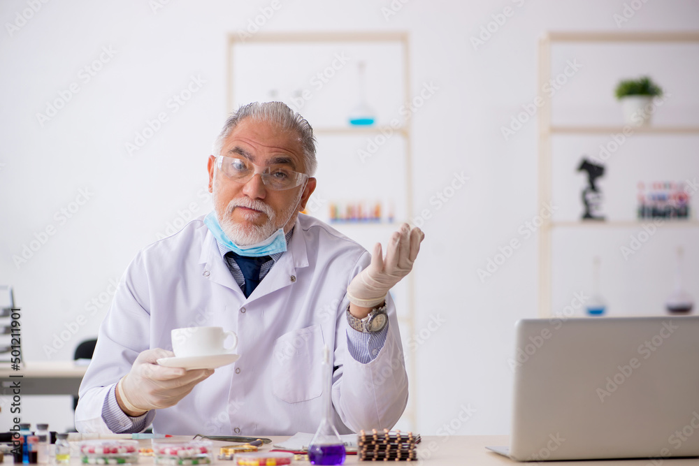 Old male chemist in drug synthesis concept