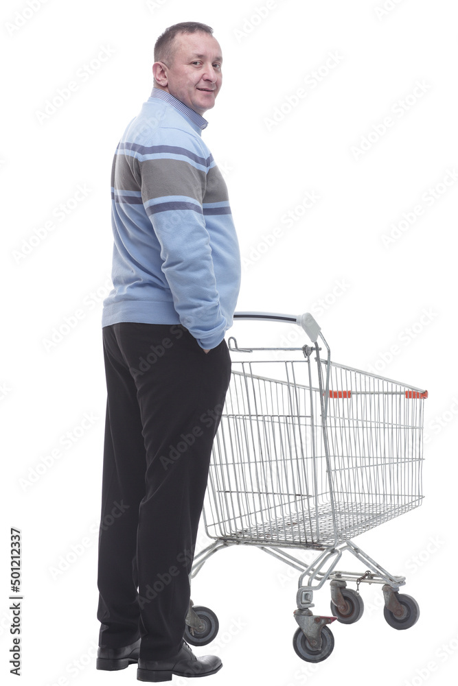 rear view. casual man with a cart standing in front of a white screen