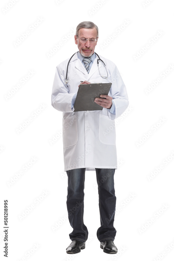 Front view of mature thoughtful doctor writing on clipboard Front view of mature thoughtful doctor writing on clipboard