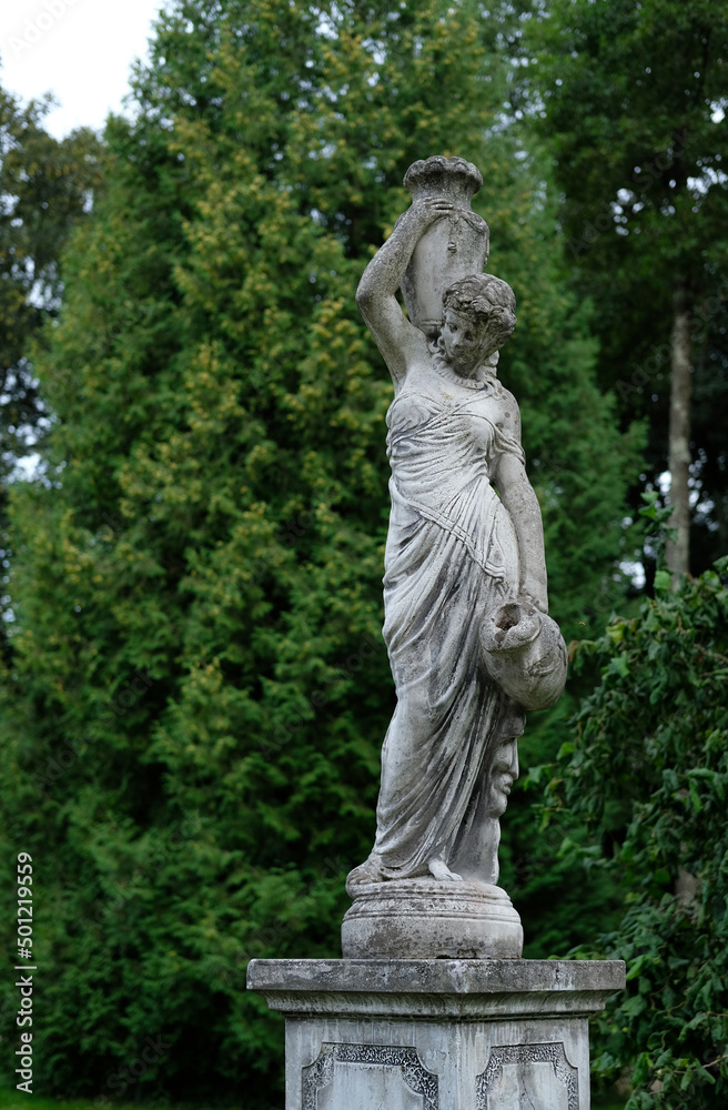statue of a woman with jugs in the park