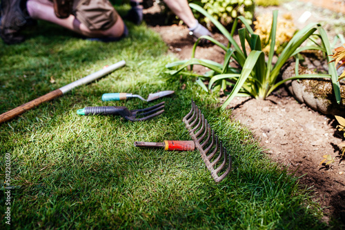Beautiful english garden and garden tools and equipment. Gardener working process